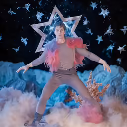 a man is shown performing in front of a star