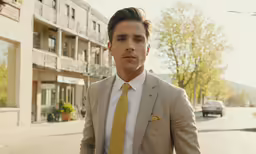 a man in a suit and yellow tie