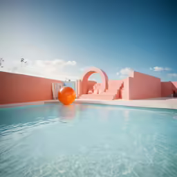 an orange ball in a pool with a pink structure