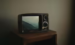 an old television sitting on top of a wooden table