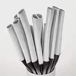 the stems of bamboo sticks are arranged in a white vase