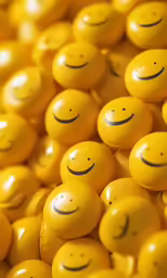 a pile of yellow balls with faces painted on them