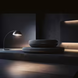 a modern lamp stands near an illuminated sofa