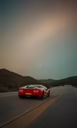 the new red sports car driving on an asphalt road