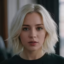 a close - up view of a woman with light hair