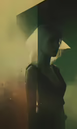 a woman in a black dress standing near a wall