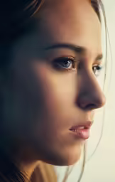 a woman in profile looking at the camera
