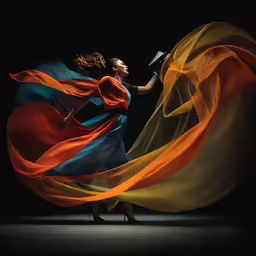 a woman in long dress with flowing fabric