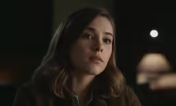 an image of a beautiful young woman staring away