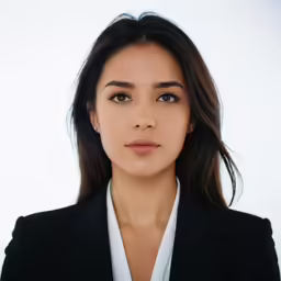 a woman is looking to the side in front of a white background