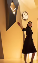 a woman in black posing in a futuristic room