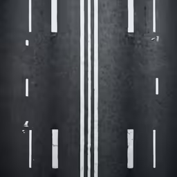 the top view of a pair of pedestrian walk way on an asphalt street