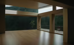 an empty room with wood floors and lots of windows