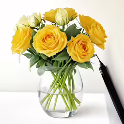 there are many yellow roses in the vase