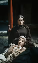 the women in the historical costumes are looking at the viewer