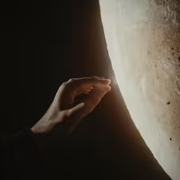 a person holding their hand in front of an object