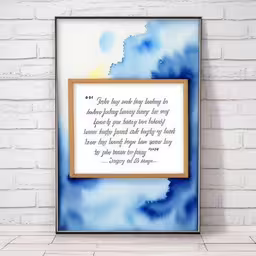 a quote is displayed above a painting on the wall,a picture frame hanging on a brick wall
