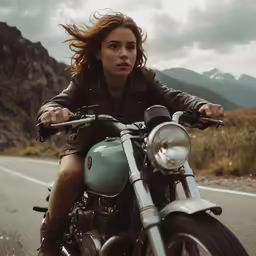 woman riding on a motorcycle down a country road
