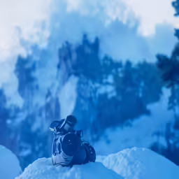 someone taking a photo of some snow capped mountains