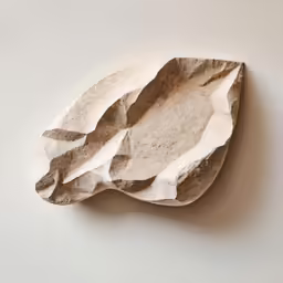 a white and brown object with a design on it