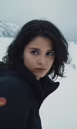 a young woman looks off into the distance