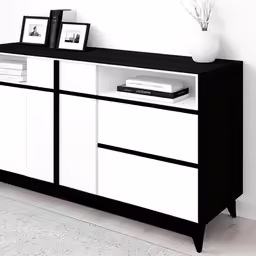 a white and black dresser sitting in a room