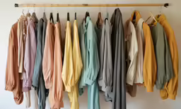 a bunch of clothes hanging up on a rack
