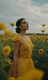 a woman in a yellow dress poses in front of sunflowers