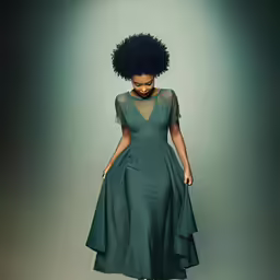 an african woman wearing a green dress and heels