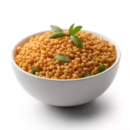 a white bowl filled with yellow seed kernels
