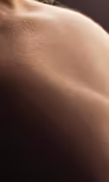 topless female torso with sun shining through the layers