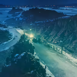 view of a road in the mountains with traffic at night