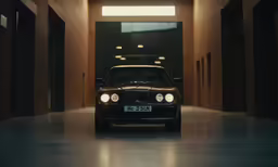 a classic bmw is shown in the middle of an empty hall