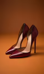 a pair of red high heel shoes on a brown surface