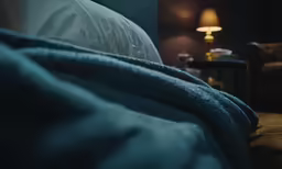 a bed with two tables and some pillows