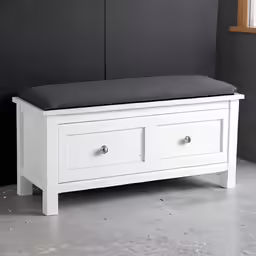 an ottoman with two drawers underneath it on a gray background