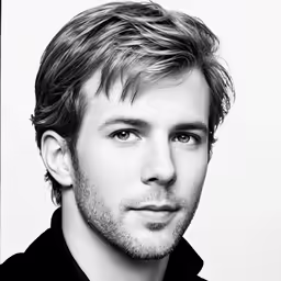 a black and white photo of a man in a black shirt