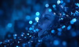 a woman covered by lights while looking at something