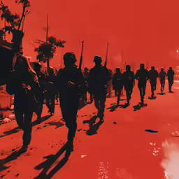 soldiers are walking on the beach near other people