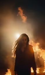 a woman standing in front of the fire