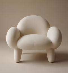 an overstuffed chair with no legs sitting up against a plain background