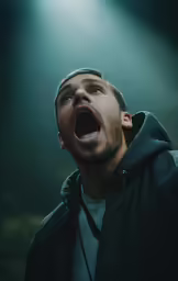 the man is screaming in front of the microphone