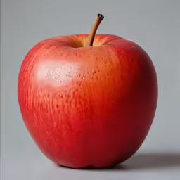 red apple with raindrops and a white background