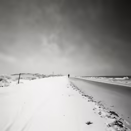 the snow is covering the road and the street lights