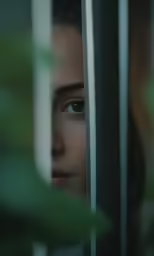 the woman is staring out of the train window