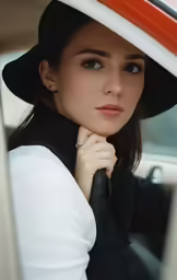 a beautiful young woman wearing a black hat