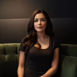 an attractive young woman posing on a couch