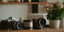 a couple of cameras sit on top of a table