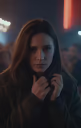 a woman who is holding something by her hand