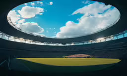 a very large empty stadium with some lights on